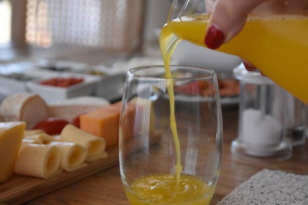 istock Pour orange juice into a glass 696365620