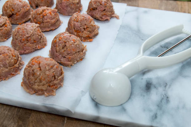 istock Meatballs preparation using ice cream scoop 696365668