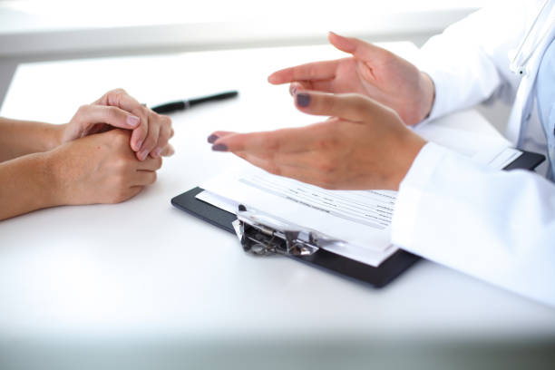 istock Doctor and patient are discussing something, just hands at the table 696368550