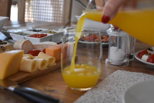 istock Pour orange juice into a glass 696368646