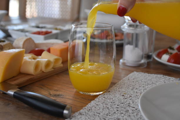 istock Pour orange juice into a glass 696369012