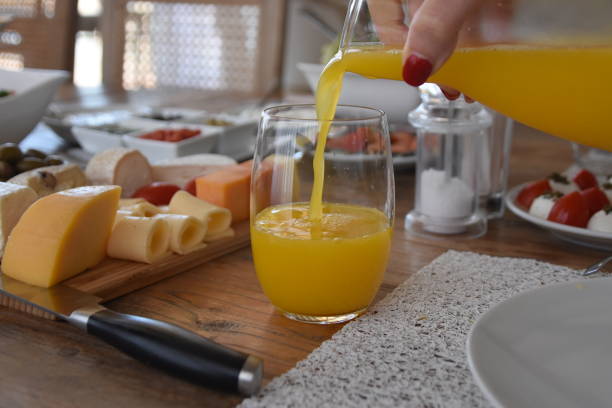 istock Pour orange juice into a glass 696369028