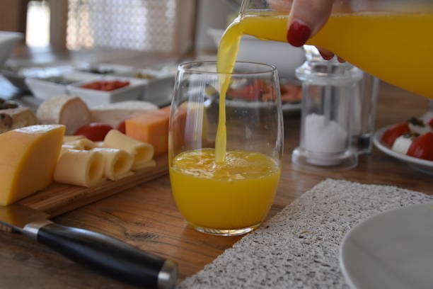 istock Pour orange juice into a glass 696371208