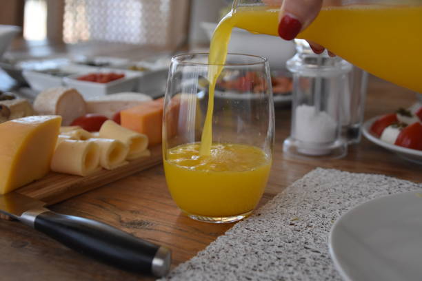 istock Pour orange juice into a glass 696371214