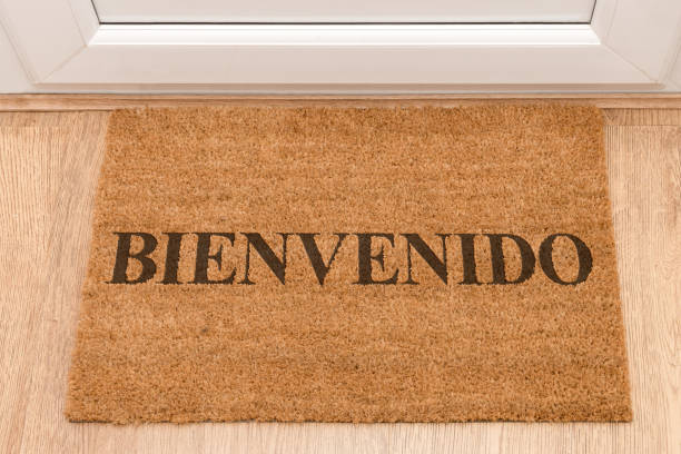 istock Door mat at front door with Welcome in Spanish - Bienvenido 696371728
