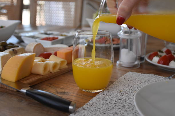istock Pour orange juice into a glass 696371896