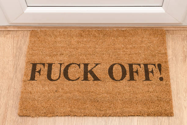 istock Door mat at front door with expletive F*CK OFF 696371956