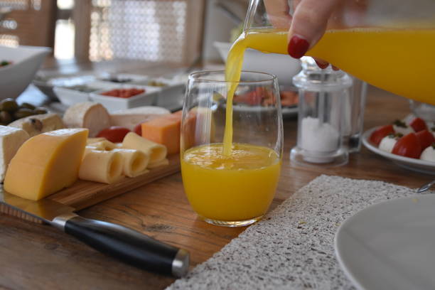 istock Pour orange juice into a glass 696372066