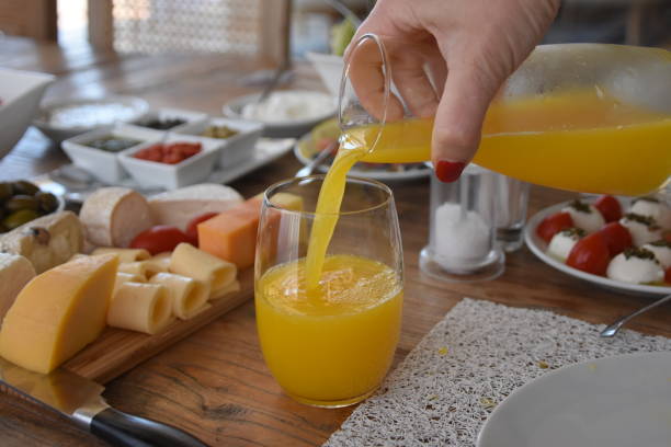 istock Pour orange juice into a glass 696372218