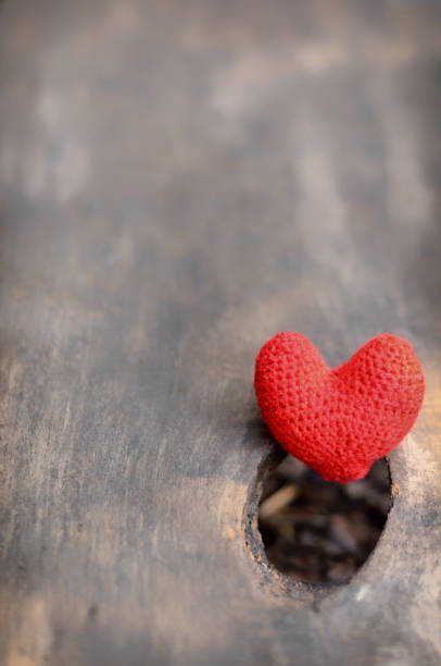 istock Red heart on wooden background 696372252