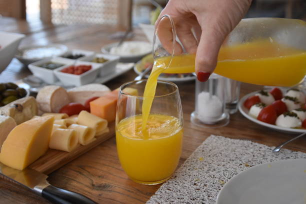 istock Pour orange juice into a glass 696372892