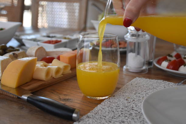 istock Pour orange juice into a glass 696372898
