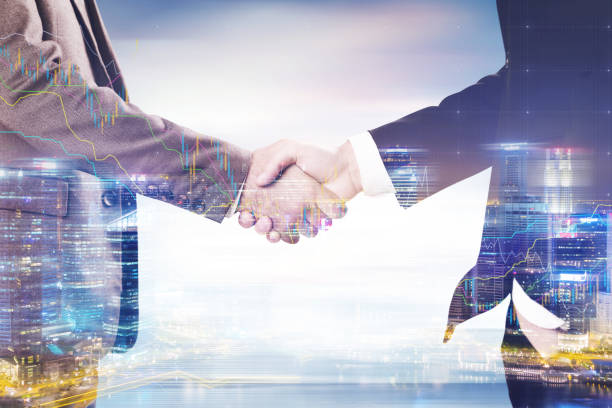 istock Businessmen s handshake in a city 696373316