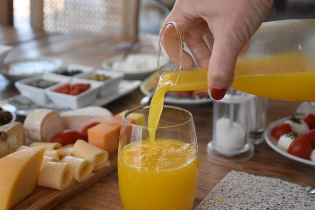 istock Pour orange juice into a glass 696373390
