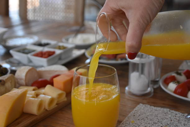 istock Pour orange juice into a glass 696373396