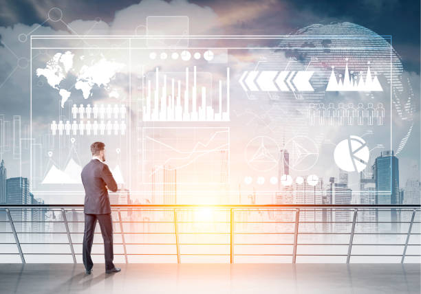istock Businessman on balcony, graphs and city 696373762