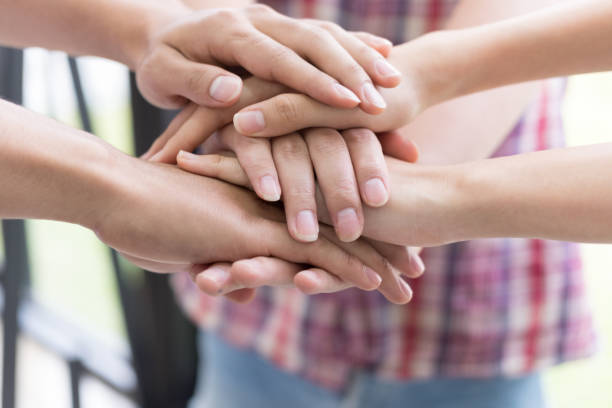 istock young college student joining hand, business team touching hands together - unity, harmony, teamwork, friends concept 696374332