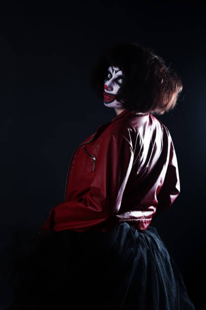 istock Girl actor with clown makeup in red leather jacket 696380016
