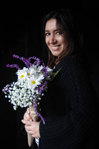 Woman smiling holding a bouquet