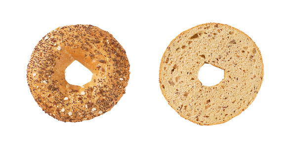 halved bagel with seeds on white background