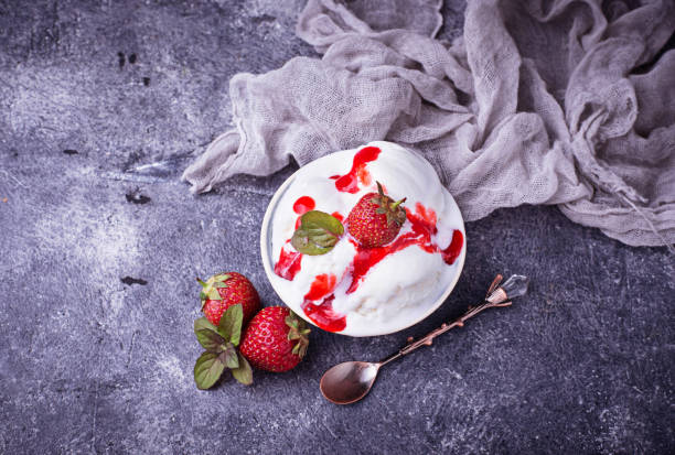 istock Ice cream with strawberry topping 696405694