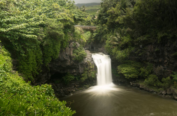 istock Waterfall under road bridge at Seven Sacred Pools Maui 696409632