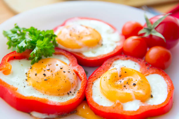 istock Fried eggs in paprika served on white plate 696409760