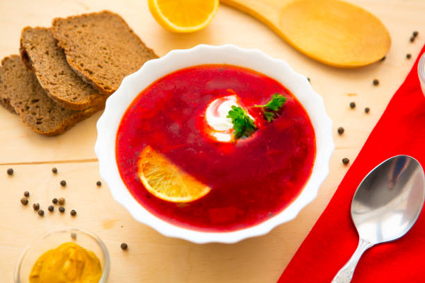 istock Borscht on wooden background 696410084