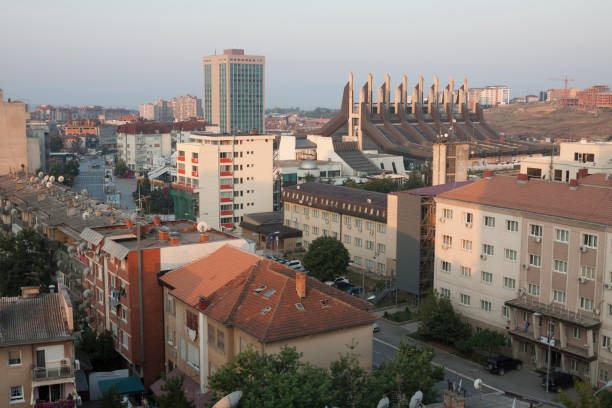 Panorama of Pristina downtown, capital of Kosovo Kosovo - Pristina - Panorama of Pristina downtown along Luan Haradinaj and Garibaldi streets and with the former sport palace in the distance at new day morning sunrise pristina stock pictures, royalty-free photos & images