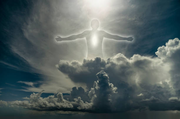 istock Religion background. Silhouette of man among the clouds 696410852