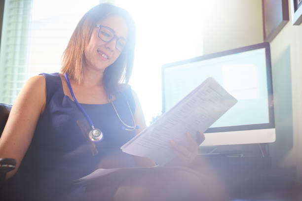 istock Smiling Doctor reading patient test results 696414228