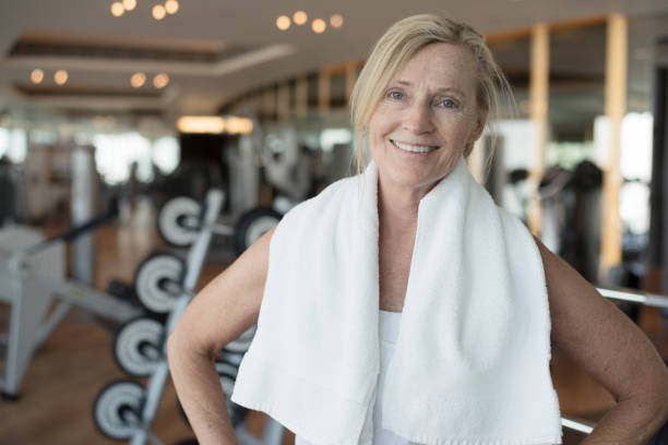 istock Mature happy woman working out 696414540