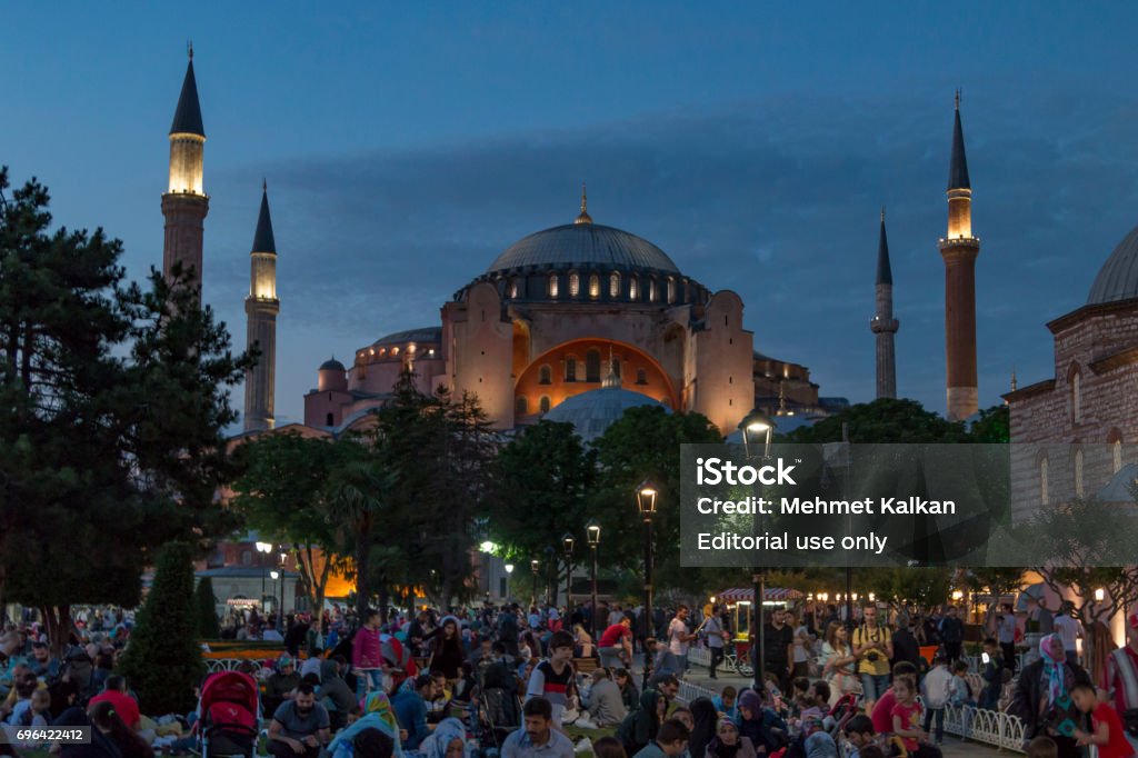 People are eating iftar(evening meal,dinner) during Ramadan in Hagia sophia square. Hagia sophia district is the most popular place for Ramadan activities in Istanbul ISTANBUL, TURKEY - JUNE 11, 2017: People are eating iftar(evening meal,dinner) during Ramadan in Hagia sophia square. Hagia sophia district is the most popular place for Ramadan activities in Istanbul 2017 Stock Photo