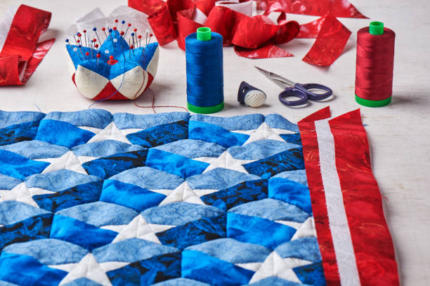 istock Sewing of quilt with stylized elements of American flag 696430692