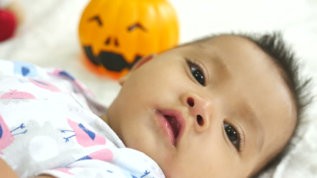 Asian baby smiling with pumpkin  toy
