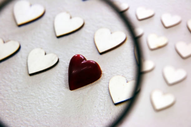istock Looking for different heart between the bunch of wooden same hearts 696432552
