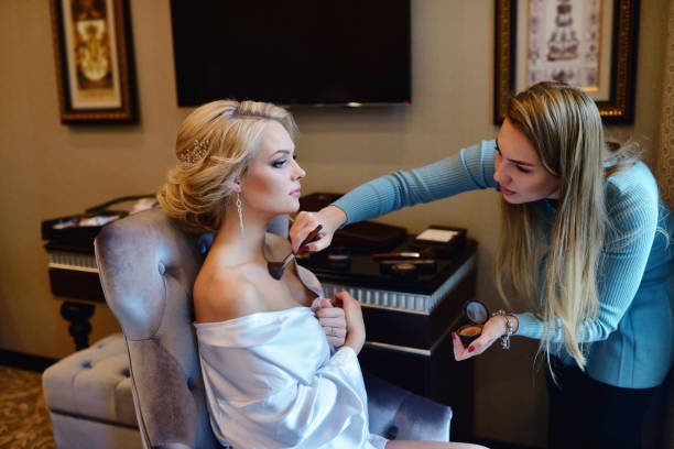 istock Wedding makeup artist making a make up for bride 696435780