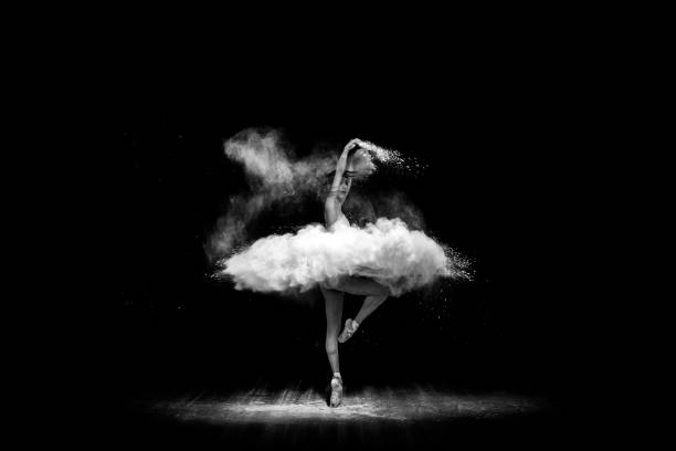 istock Beautiful ballet dancer, dancing with powder on stage 696436672