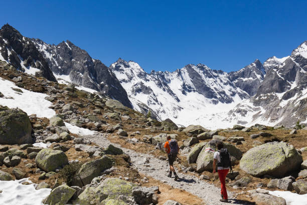 istock Hikers are walking on high mountain trail 696437164