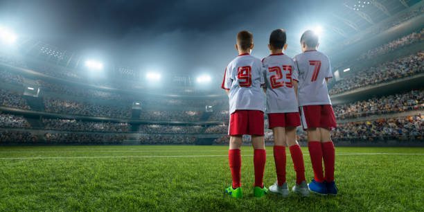 istock Soccer kids player makes a free kick 696437214