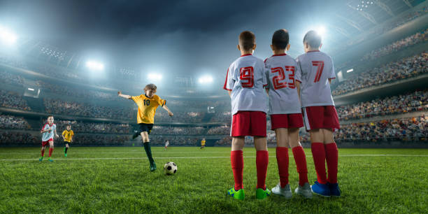 istock Soccer kids player makes a free kick 696437252