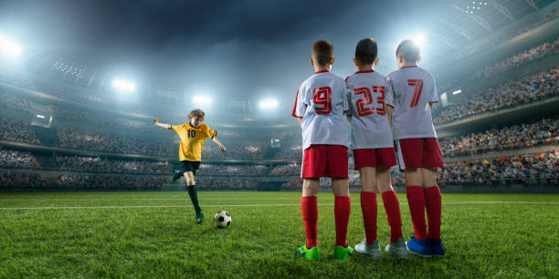 istock Soccer kids player makes a free kick 696437260