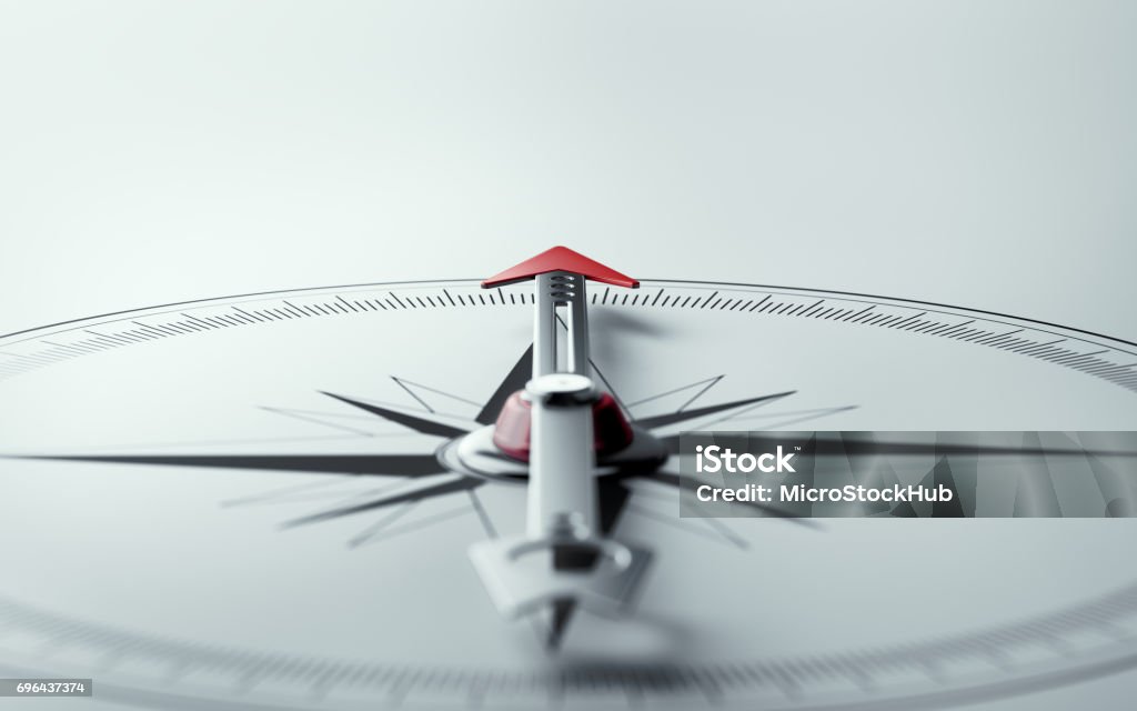 Compass on White Background with Selective Focus Compass on white background with selective focus. Compass is lit from the upper left corner of composition. Horizontal composition with copy space. Navigational Compass Stock Photo