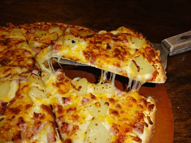 istock Cheesy pizza slice lifted off the plate by spatula 696441162