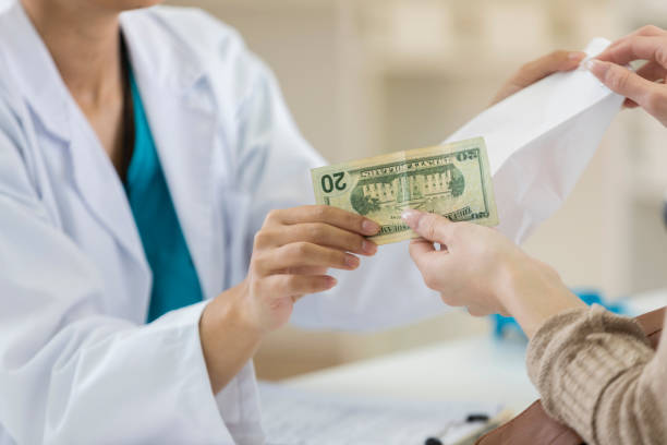 istock Pharmacy customers pays for purchase at checkout counter 696450102