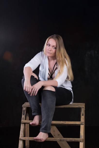 istock Blond woman on a dark background 696453664