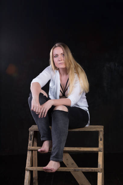 istock Blond woman on a dark background 696453668