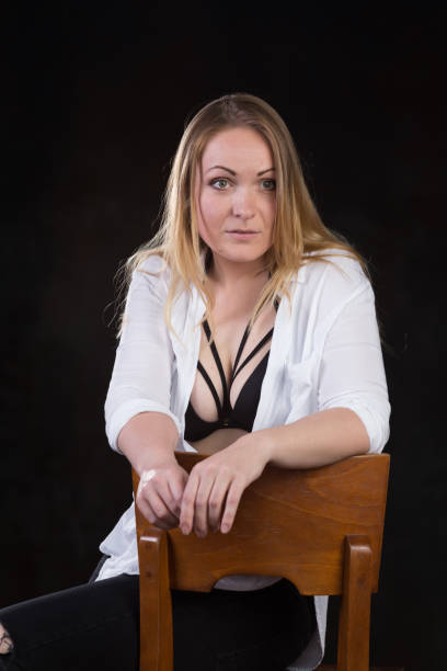 istock Blond woman on a dark background 696453770