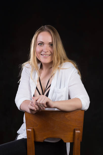 istock Blond woman on a dark background 696453782