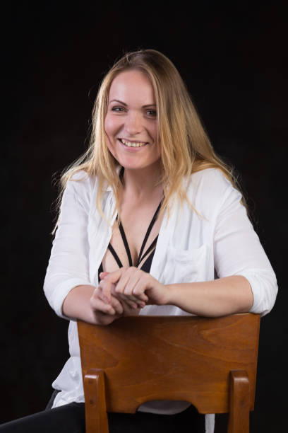 istock Blond woman on a dark background 696453786
